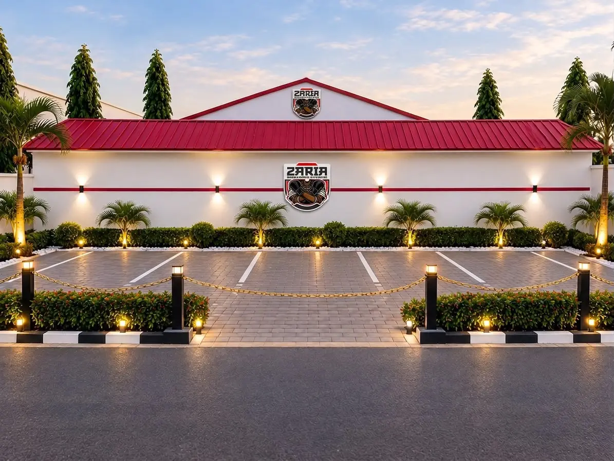 The centre's red-roofed frontage with the ZARIA crest and a lit parking area.